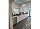 Full kitchen view showing white cabinetry, stainless steel appliances, and a colorful rug at 1020 38Th N Ave, St Petersburg, FL 33704