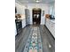 Bright kitchen with a long decorative rug, stainless steel appliances, and a view into the dining room at 1020 38Th N Ave, St Petersburg, FL 33704