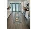 Kitchen featuring white cabinets, stainless appliances, blue trim doors and a vibrant rug at 1020 38Th N Ave, St Petersburg, FL 33704