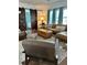 Open-concept living room with a stylish leather sectional and sliding barn doors leading to the bedroom at 1020 38Th N Ave, St Petersburg, FL 33704