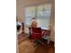 Bright office with a desk, red chair, and a vintage washing machine in the corner at 1020 38Th N Ave, St Petersburg, FL 33704