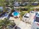 Aerial view of the backyard pool, lush landscaping, and patio furniture provides relaxation and comfort in the private oasis at 1020 38Th N Ave, St Petersburg, FL 33704