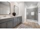 Elegant bathroom with double vanity, contemporary fixtures, and a glass-enclosed shower at 10709 Wading River Ave, Parrish, FL 34219