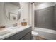 Modern bathroom features a tiled shower-tub combination, stylish vanity, and neutral color palette at 10709 Wading River Ave, Parrish, FL 34219