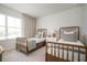 Bright bedroom with twin beds, decorative wallpaper, and natural light from a large window at 10709 Wading River Ave, Parrish, FL 34219
