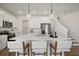 Modern kitchen with a large island, white cabinetry, stainless steel appliances, and pendant lighting at 10709 Wading River Ave, Parrish, FL 34219