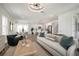 Open concept living area with dining area, bright kitchen, and stylish furnishings at 10709 Wading River Ave, Parrish, FL 34219