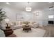 Bright living room featuring modern decor, comfortable seating, and stylish lighting fixtures at 10709 Wading River Ave, Parrish, FL 34219