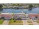 Waterfront home featuring solar panels, a well maintained lawn, and attached garage at 1118 Lodestar Dr, Holiday, FL 34690
