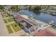 Waterfront home features solar panels, a pool, and a private dock on a canal at 1118 Lodestar Dr, Holiday, FL 34690