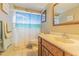 Bathroom features a beach themed shower curtain, wood vanity, and tiled floors at 1118 Lodestar Dr, Holiday, FL 34690
