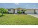Charming single-story home with a well-maintained lawn, inviting front porch, and mature landscaping at 1118 Lodestar Dr, Holiday, FL 34690
