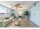 Inviting living room featuring modern ceiling fan, sliding barn door and comfortable seating area at 1118 Lodestar Dr, Holiday, FL 34690