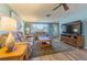 Cozy living room with wood-look floors, a neutral color palette and plenty of natural light at 1118 Lodestar Dr, Holiday, FL 34690