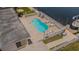 Aerial view of a kidney-shaped pool with surrounding patio and boat dock at 1118 Lodestar Dr, Holiday, FL 34690