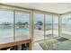 Sunroom with views of the pool and lake, bright tile floor, and large windows at 1118 Lodestar Dr, Holiday, FL 34690