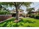 Well manicured backyard with a putting green, hot tub, shade tree, and outdoor seating at 1210 Bay Pine Blvd, Indian Rocks Beach, FL 33785
