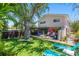 Beautiful backyard with lush landscaping, putting green, hot tub, and patio for outdoor enjoyment at 1210 Bay Pine Blvd, Indian Rocks Beach, FL 33785
