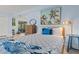 Bright and open bedroom featuring a twin bed, dresser, and beach-themed decor at 1210 Bay Pine Blvd, Indian Rocks Beach, FL 33785