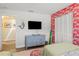 Charming bedroom with flamingo wallpaper, a modern dresser, and stylish coastal accents at 1210 Bay Pine Blvd, Indian Rocks Beach, FL 33785