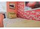 Cozy bedroom showcasing bright flamingo wallpaper, colorful floral bedding, and natural light at 1210 Bay Pine Blvd, Indian Rocks Beach, FL 33785