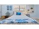 Comfortable bedroom with a twin bed, coastal artwork, and stylish lighting at 1210 Bay Pine Blvd, Indian Rocks Beach, FL 33785