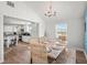 Sunlit dining room with a rustic table, woven chairs, and a view into the modern kitchen at 1210 Bay Pine Blvd, Indian Rocks Beach, FL 33785