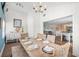 Open dining area with a large wooden table and woven chairs, seamlessly connected to the living room at 1210 Bay Pine Blvd, Indian Rocks Beach, FL 33785