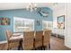 Dining space with a large table, woven chairs, coastal decor, and ample natural light at 1210 Bay Pine Blvd, Indian Rocks Beach, FL 33785