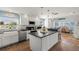 Bright kitchen featuring a large island with granite countertops and stainless steel appliances at 1210 Bay Pine Blvd, Indian Rocks Beach, FL 33785