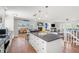 Open-concept kitchen with an island that opens to dining and living area in a bright and airy home at 1210 Bay Pine Blvd, Indian Rocks Beach, FL 33785