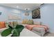 Comfortable living room with bright blue walls, coastal art, and stylish decor at 1210 Bay Pine Blvd, Indian Rocks Beach, FL 33785