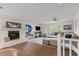 Cozy living room with fireplace, comfortable seating, and natural light at 1210 Bay Pine Blvd, Indian Rocks Beach, FL 33785