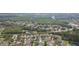Wide aerial view of a neighborhood surrounded by lush green foliage and water features at 12204 Coldstream Ln, Tampa, FL 33626