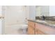 Clean bathroom featuring a tub, shower, and vanity with granite countertop at 12204 Coldstream Ln, Tampa, FL 33626