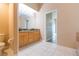Bathroom featuring a double sink vanity and a walk-in shower at 12204 Coldstream Ln, Tampa, FL 33626