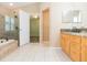 Bathroom with double vanity, granite countertops, shower, and soaking tub at 12204 Coldstream Ln, Tampa, FL 33626