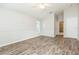 Spacious bedroom with wood-look flooring, neutral walls, and vaulted ceiling at 12204 Coldstream Ln, Tampa, FL 33626