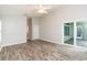 Bedroom features laminate floors, sliding glass doors leading to patio at 12204 Coldstream Ln, Tampa, FL 33626