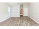 Bedroom features natural light, laminate flooring, and neutral paint at 12204 Coldstream Ln, Tampa, FL 33626