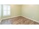 Bedroom features natural light, laminate flooring, and neutral paint at 12204 Coldstream Ln, Tampa, FL 33626