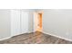 Bedroom features laminate flooring, closet, and neutral paint at 12204 Coldstream Ln, Tampa, FL 33626
