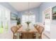 Light-filled dining area with a wooden table, seating for six, and access to the outdoors at 12204 Coldstream Ln, Tampa, FL 33626
