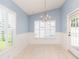 Bright dining area with tiled floor, shuttered window and a glass paned door to the pool at 12204 Coldstream Ln, Tampa, FL 33626