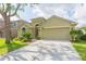 Charming single-story home with well-manicured lawn, mature trees, and a two-car garage at 12204 Coldstream Ln, Tampa, FL 33626