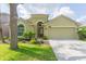 Charming single-story home with well-manicured lawn, mature trees, and a two-car garage at 12204 Coldstream Ln, Tampa, FL 33626
