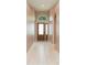 Inviting foyer with a decorative front door, tile flooring, and neutral wall paint at 12204 Coldstream Ln, Tampa, FL 33626