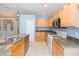 Bright kitchen featuring granite countertops, stainless steel appliances, and ample cabinet space at 12204 Coldstream Ln, Tampa, FL 33626