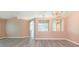 Open-concept living room featuring wood floors, neutral walls, and natural light at 12204 Coldstream Ln, Tampa, FL 33626
