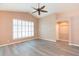 Bright living room with shuttered windows, ceiling fan and gray floors at 12204 Coldstream Ln, Tampa, FL 33626
